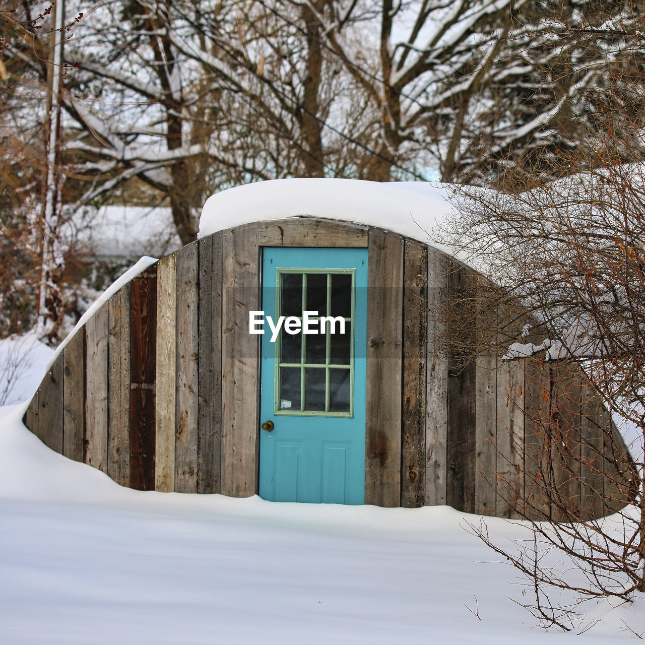 SNOW COVERED HOUSE BY BUILDING