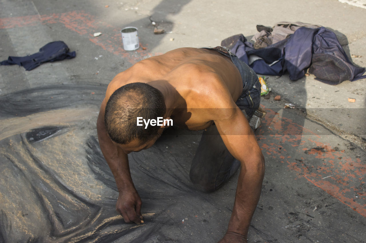 High angle view of man drawing on street