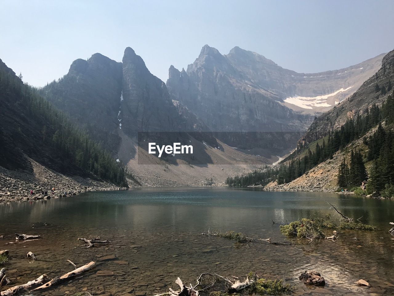 Scenic view of lake and mountains against clear sky