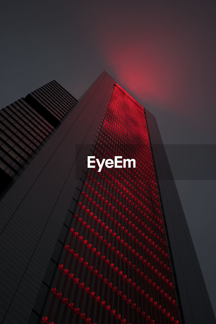 Low angle view of modern building against sky during sunset