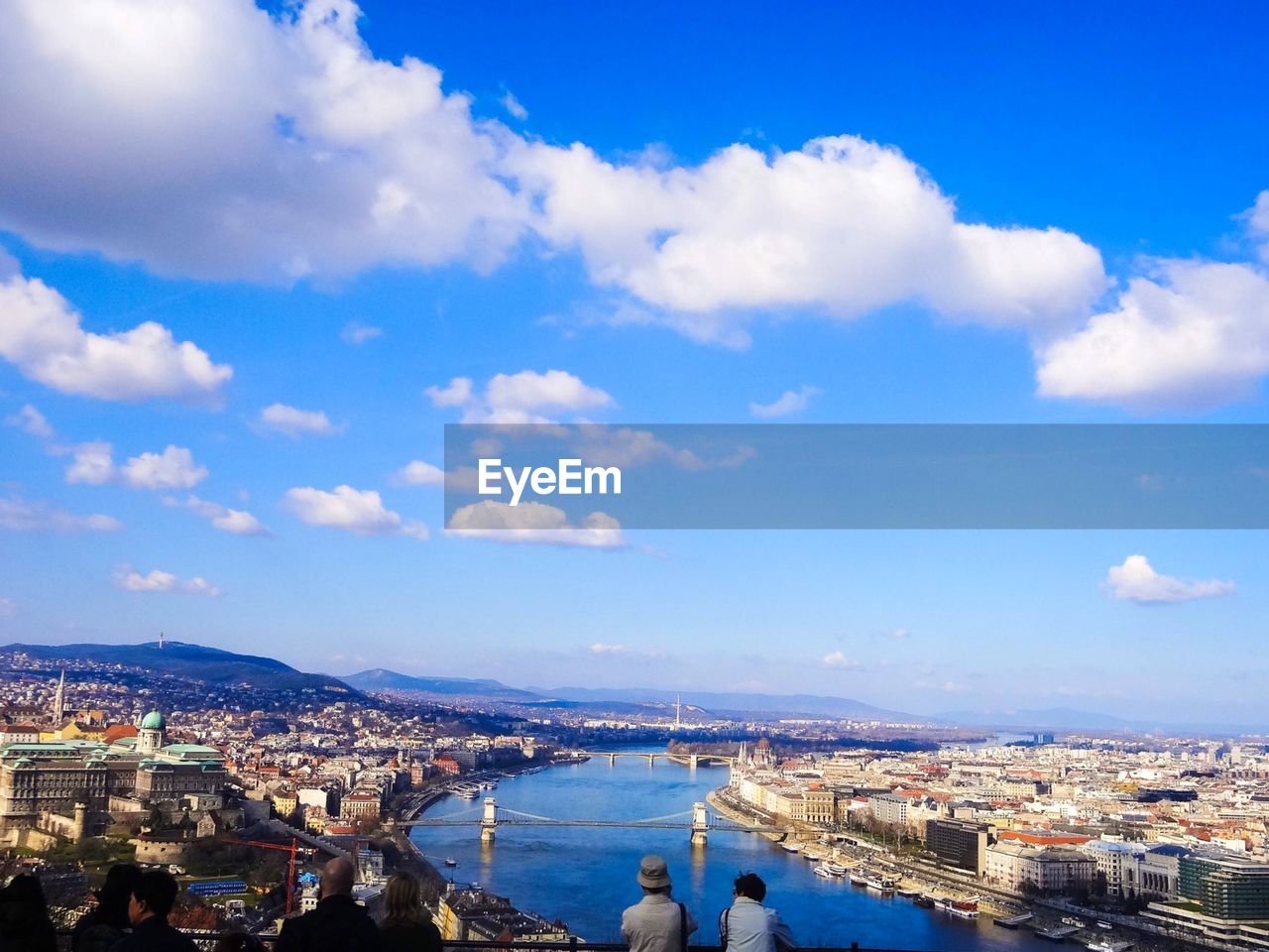 HIGH ANGLE VIEW OF TOWNSCAPE AGAINST BLUE SKY