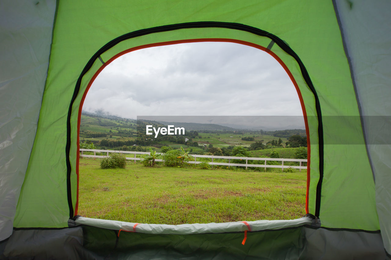 SCENIC VIEW OF FIELD AGAINST SKY SEEN THROUGH WINDOW