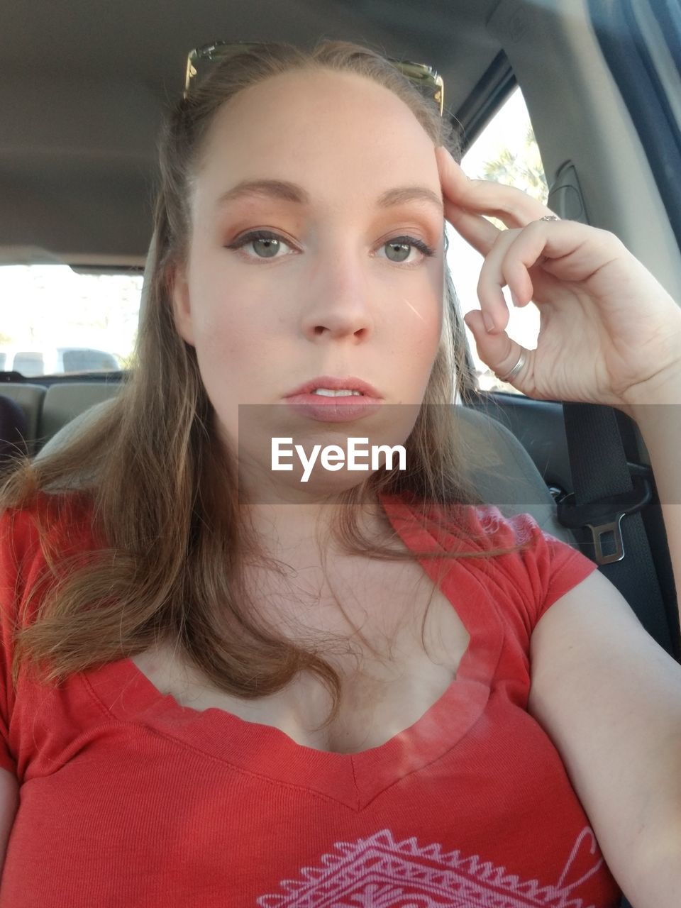 Portrait of beautiful young woman sitting in car