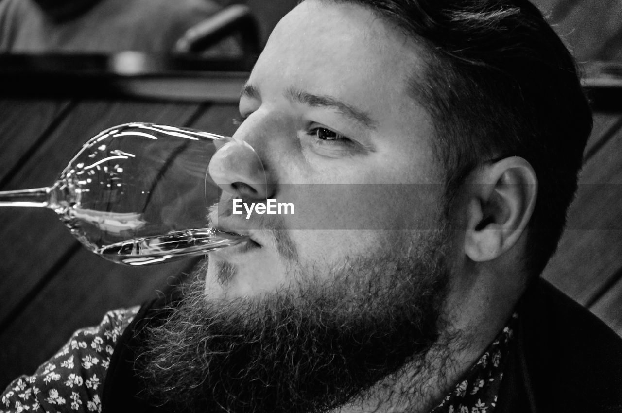 Close-up of man drinking glass