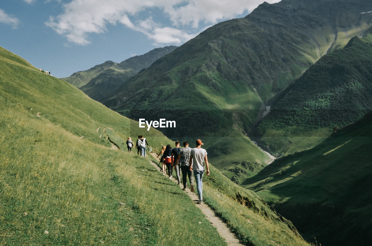 PEOPLE WALKING ON MOUNTAINS