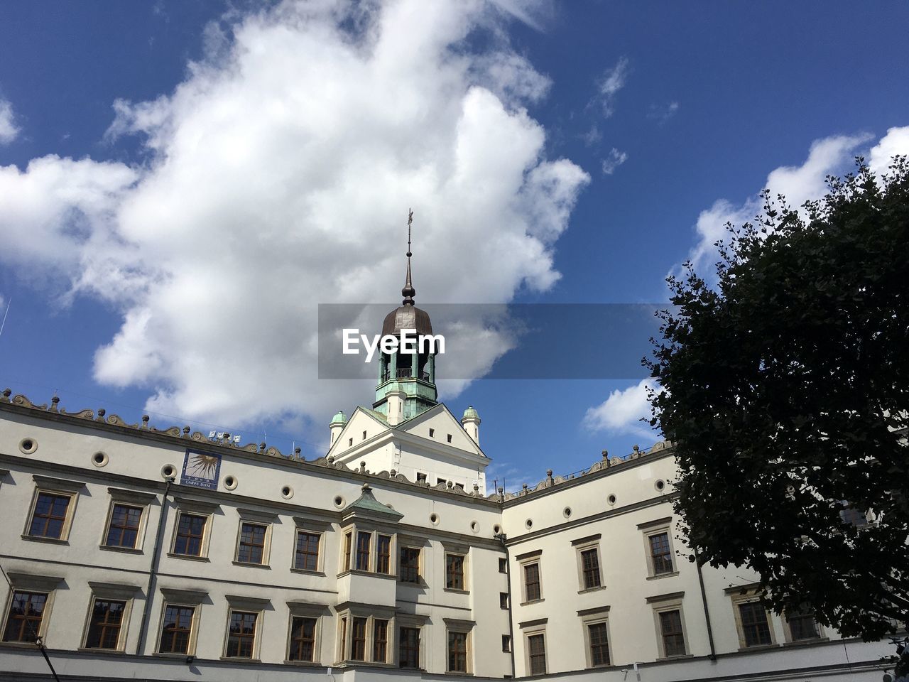 Low angle view of building against cloudy sky