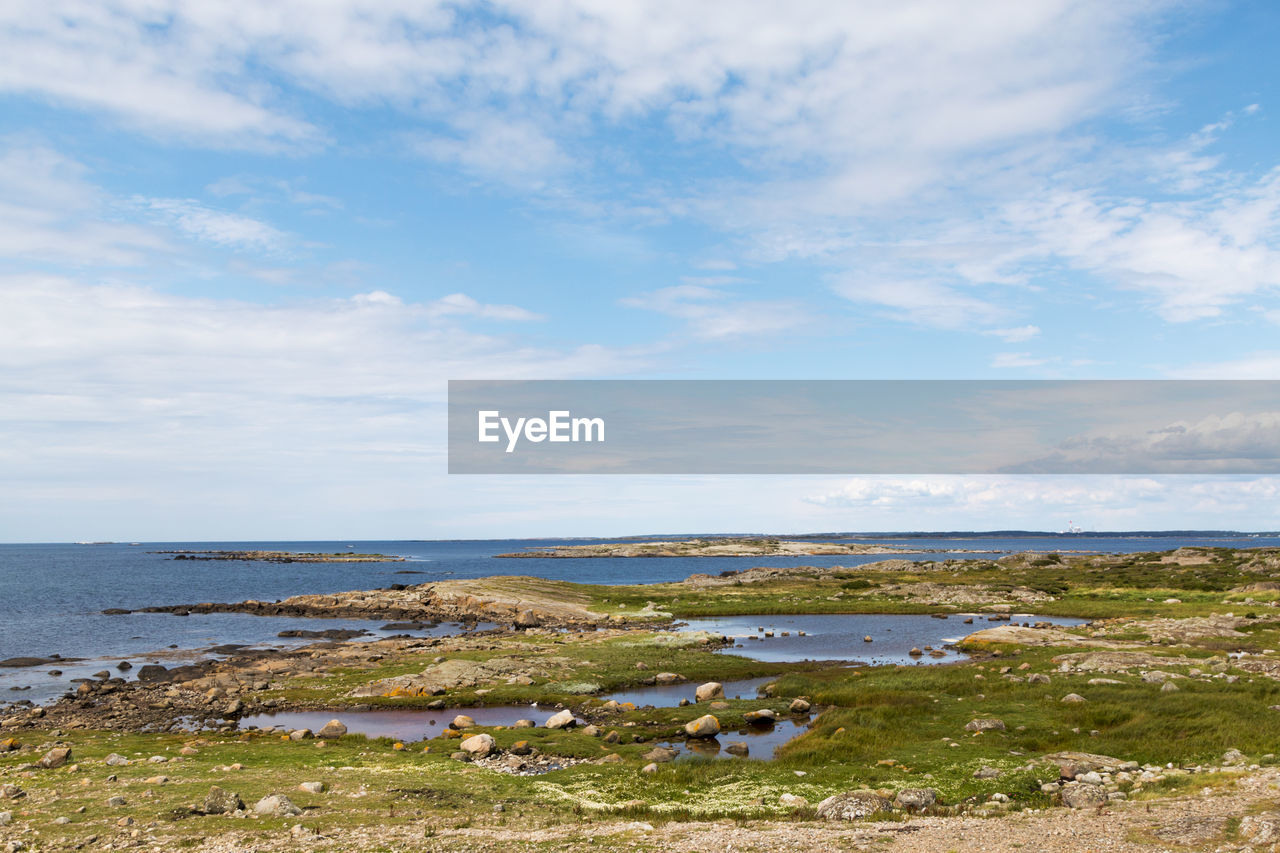 scenic view of sea against cloudy sky