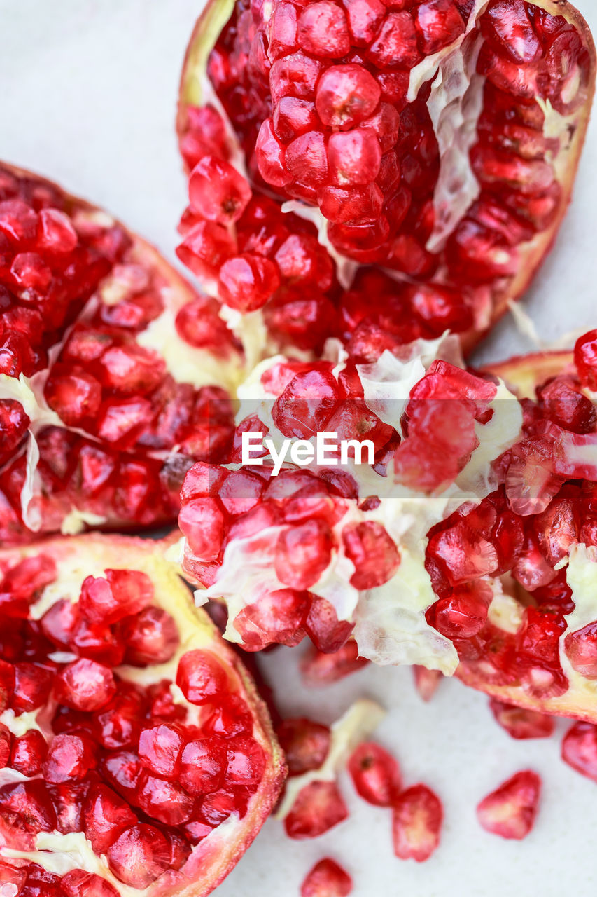 food and drink, food, pomegranate, healthy eating, plant, red, fruit, freshness, wellbeing, seed, pomegranate seed, produce, berry, berries, no people, studio shot, close-up, raspberry, antioxidant, cross section, juicy, high angle view, indoors, ripe, still life