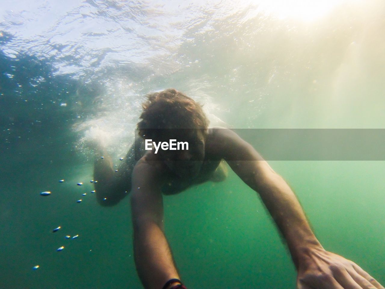 Young man swimming in sea