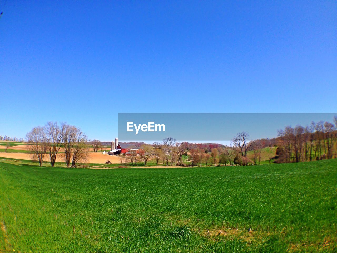 Countryside landscape against clear blue sky