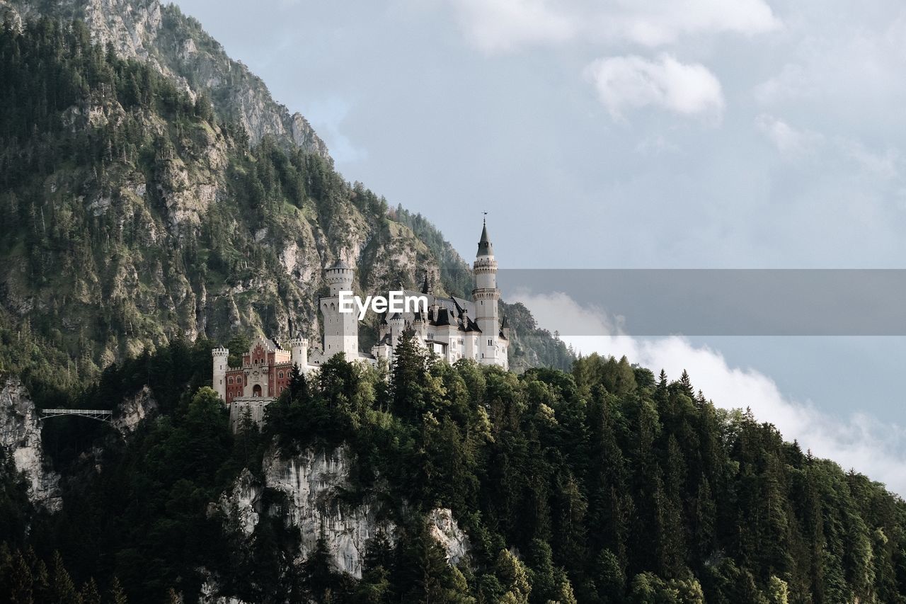 Panoramic view of trees and castle against sky