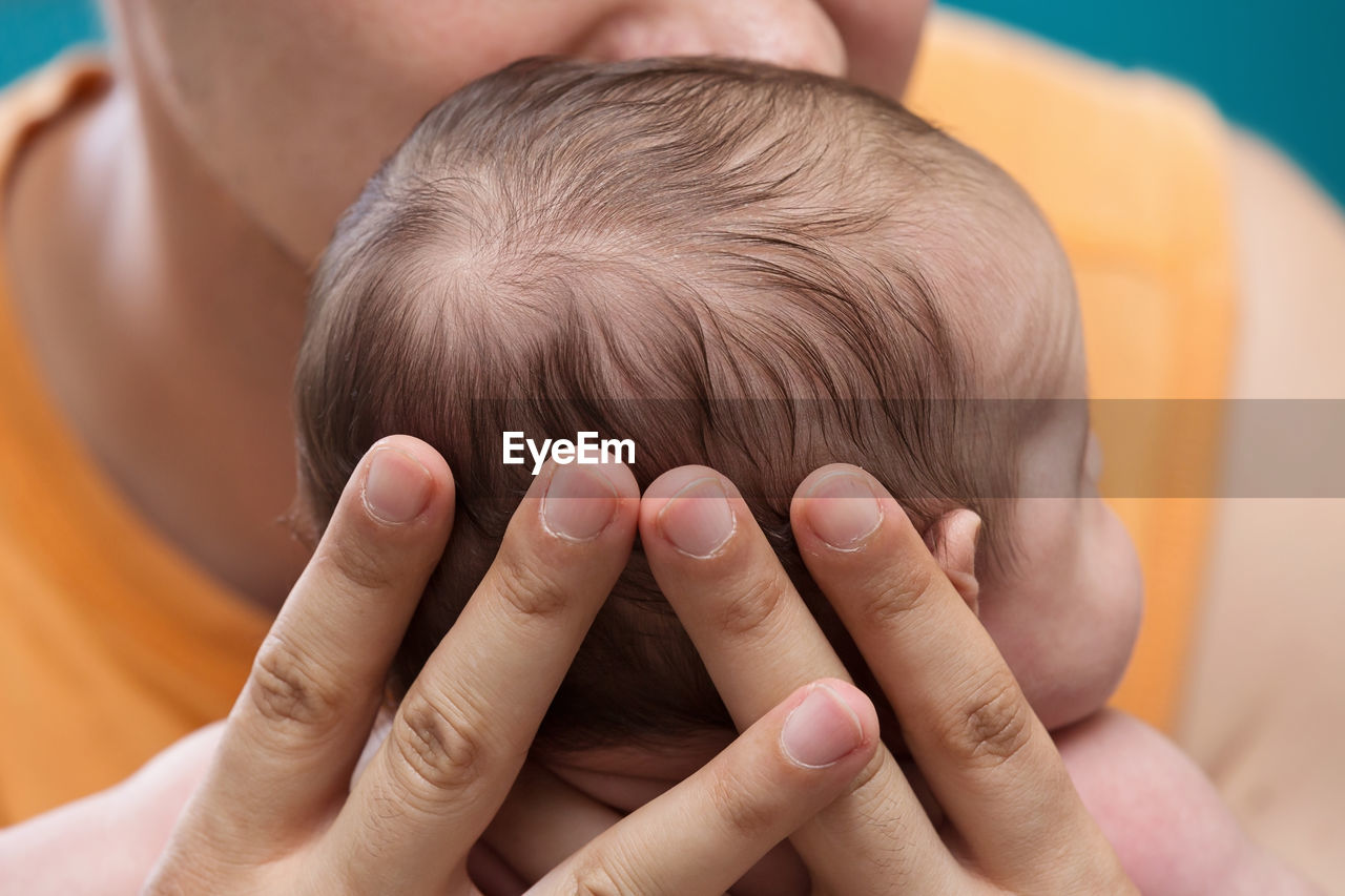 CLOSE-UP PORTRAIT OF BOY WITH BABY