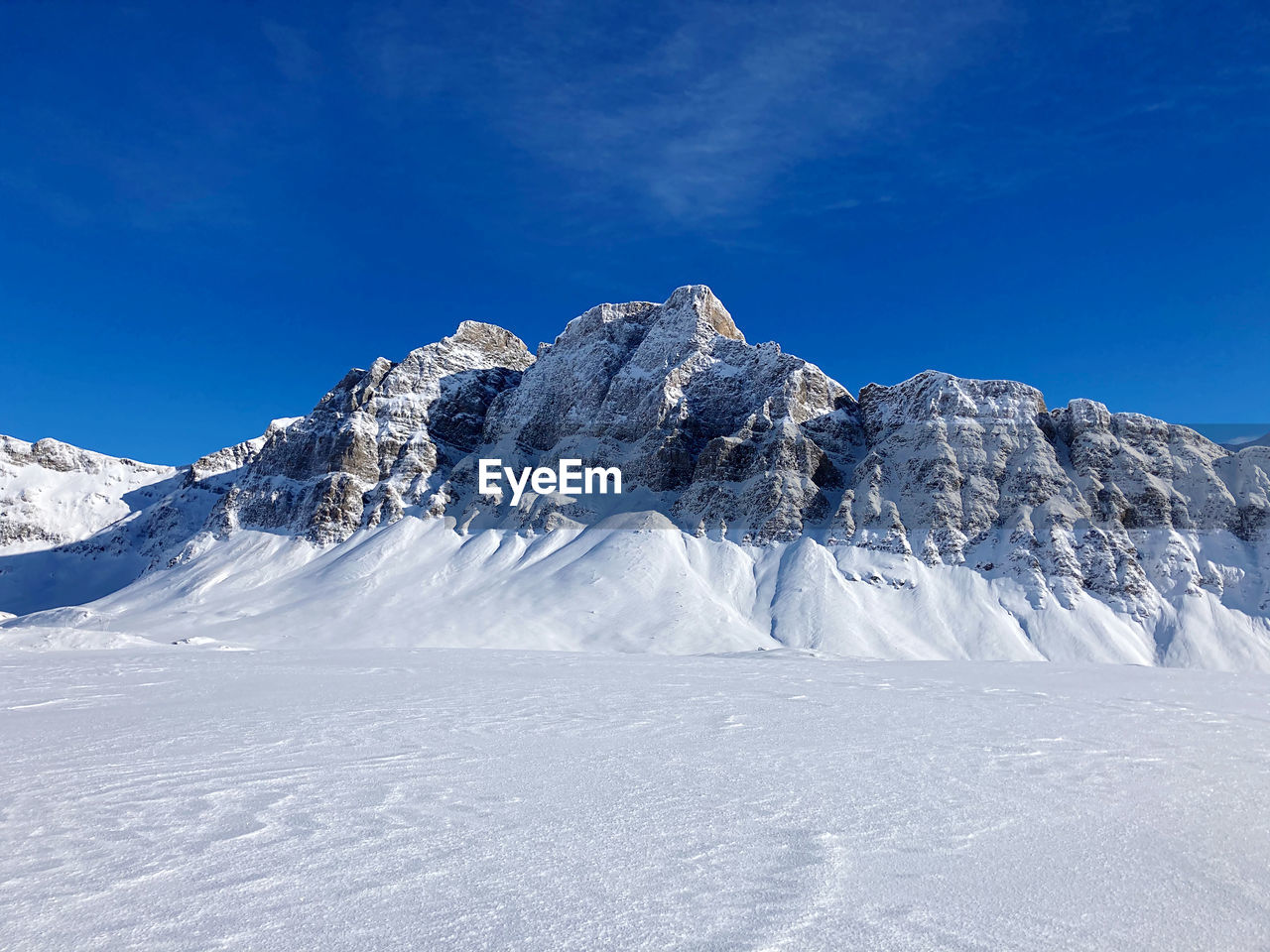 Snowcapped mountains against blue sky