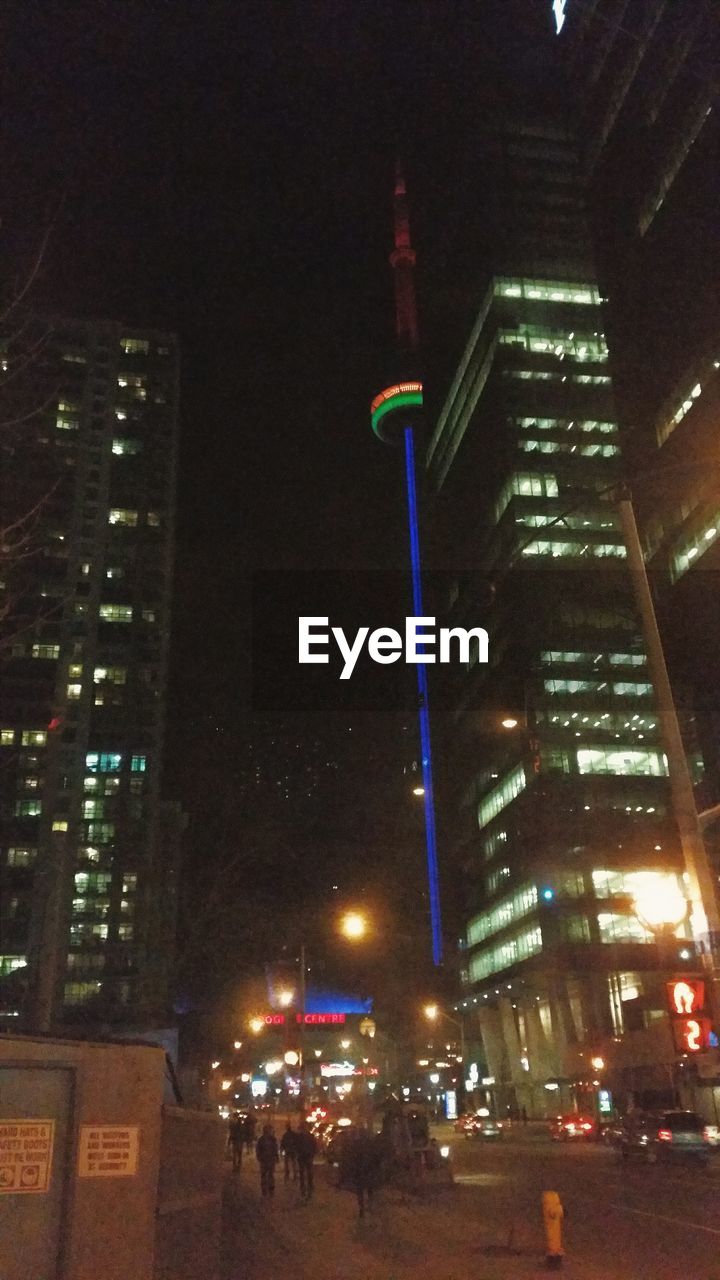 Illuminated city by cn tower against clear sky at night