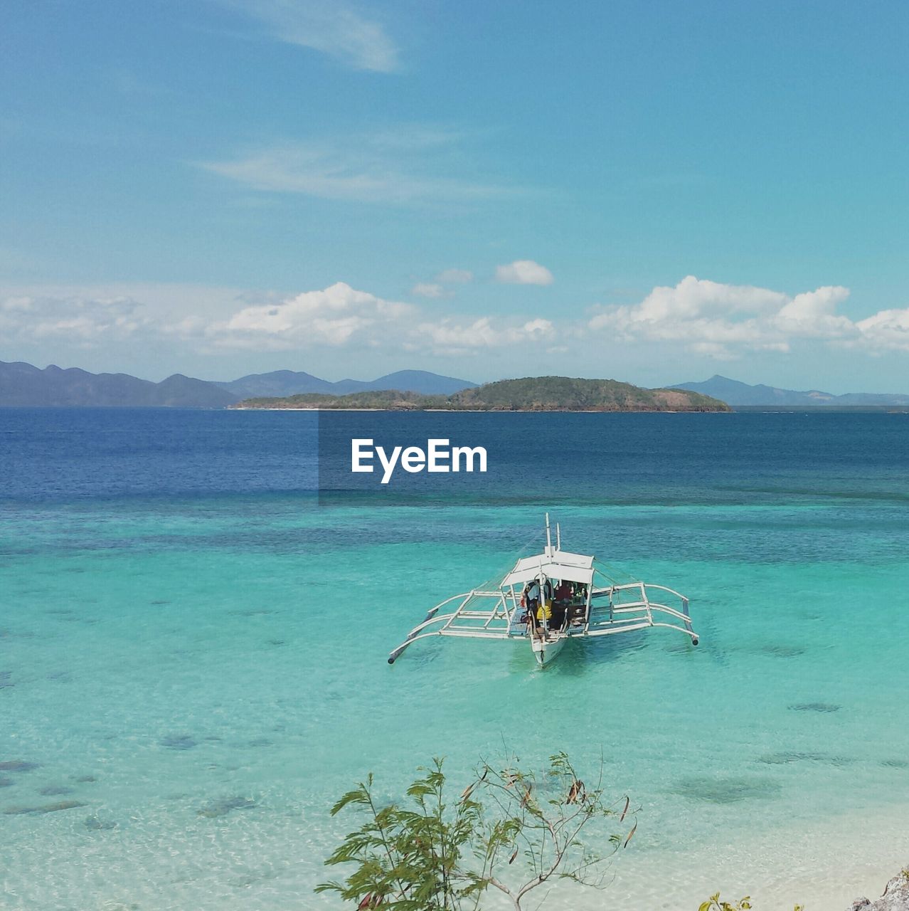 High angle view of outrigger canoe on sea against sky