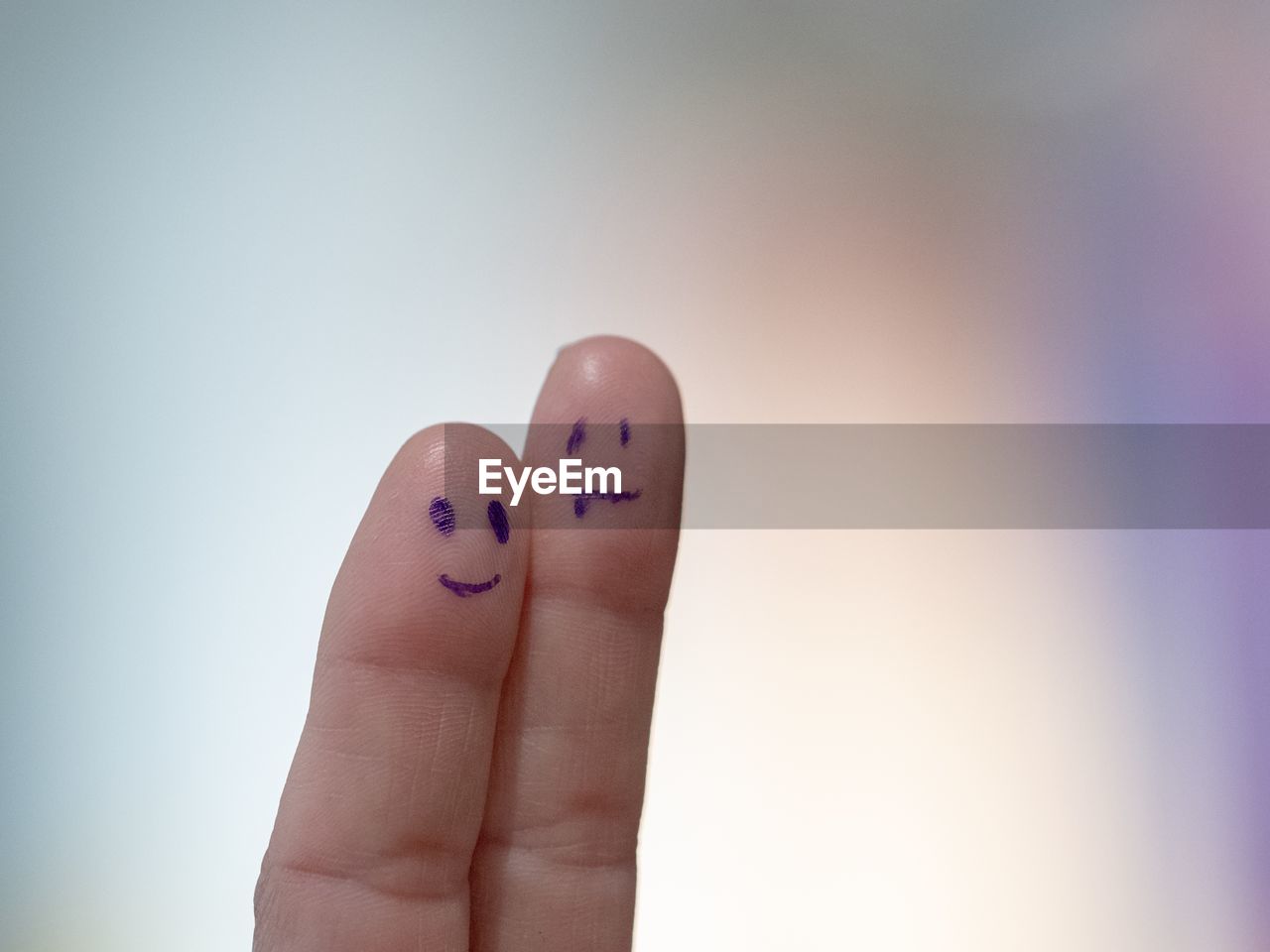 Close-up of cropped fingers with anthropomorphic faces