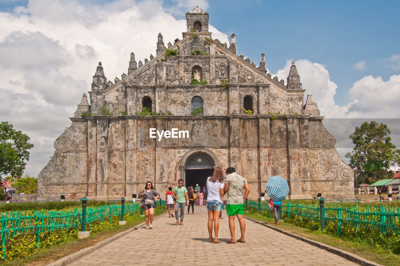 PEOPLE WALKING ON HISTORICAL BUILDING AGAINST SKY