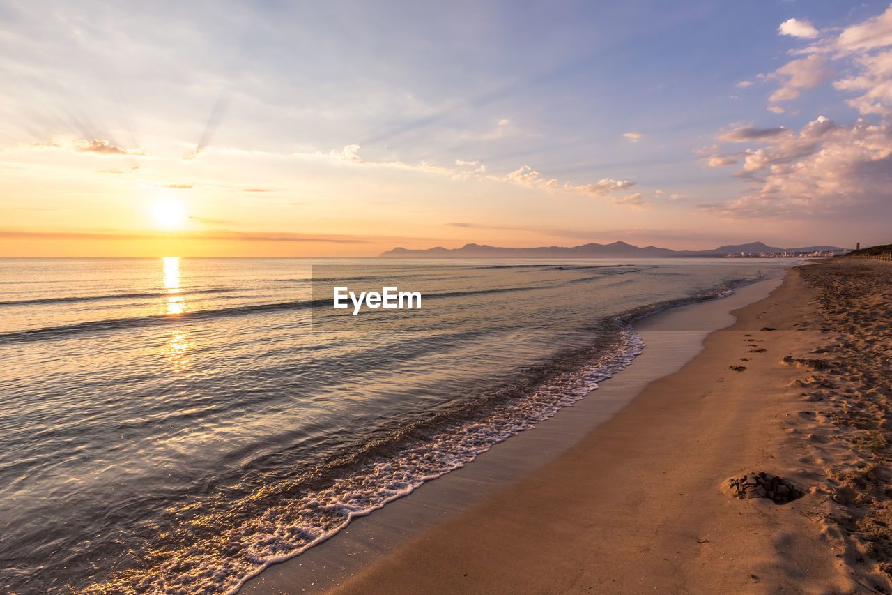 SCENIC VIEW OF BEACH DURING SUNSET