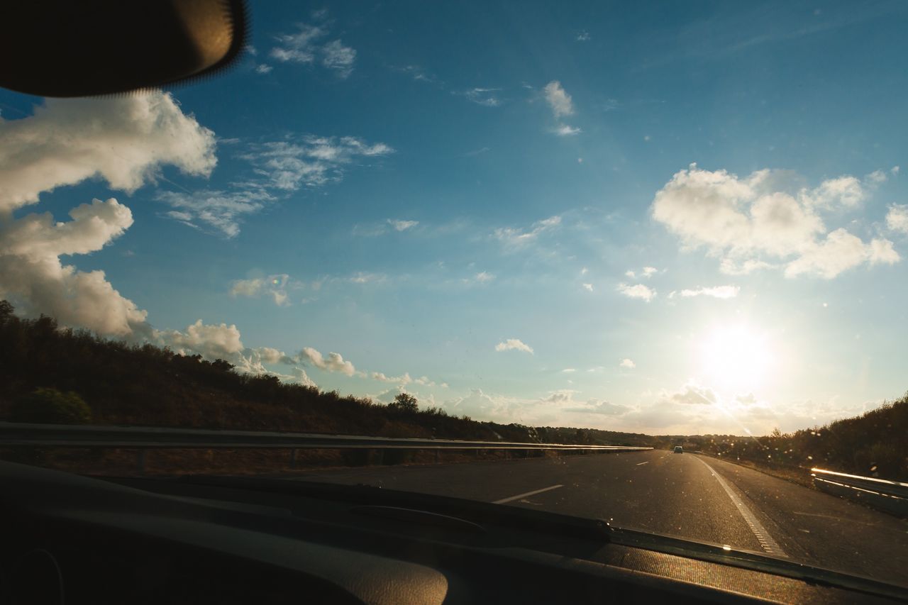 Blue sky seen through car windshield