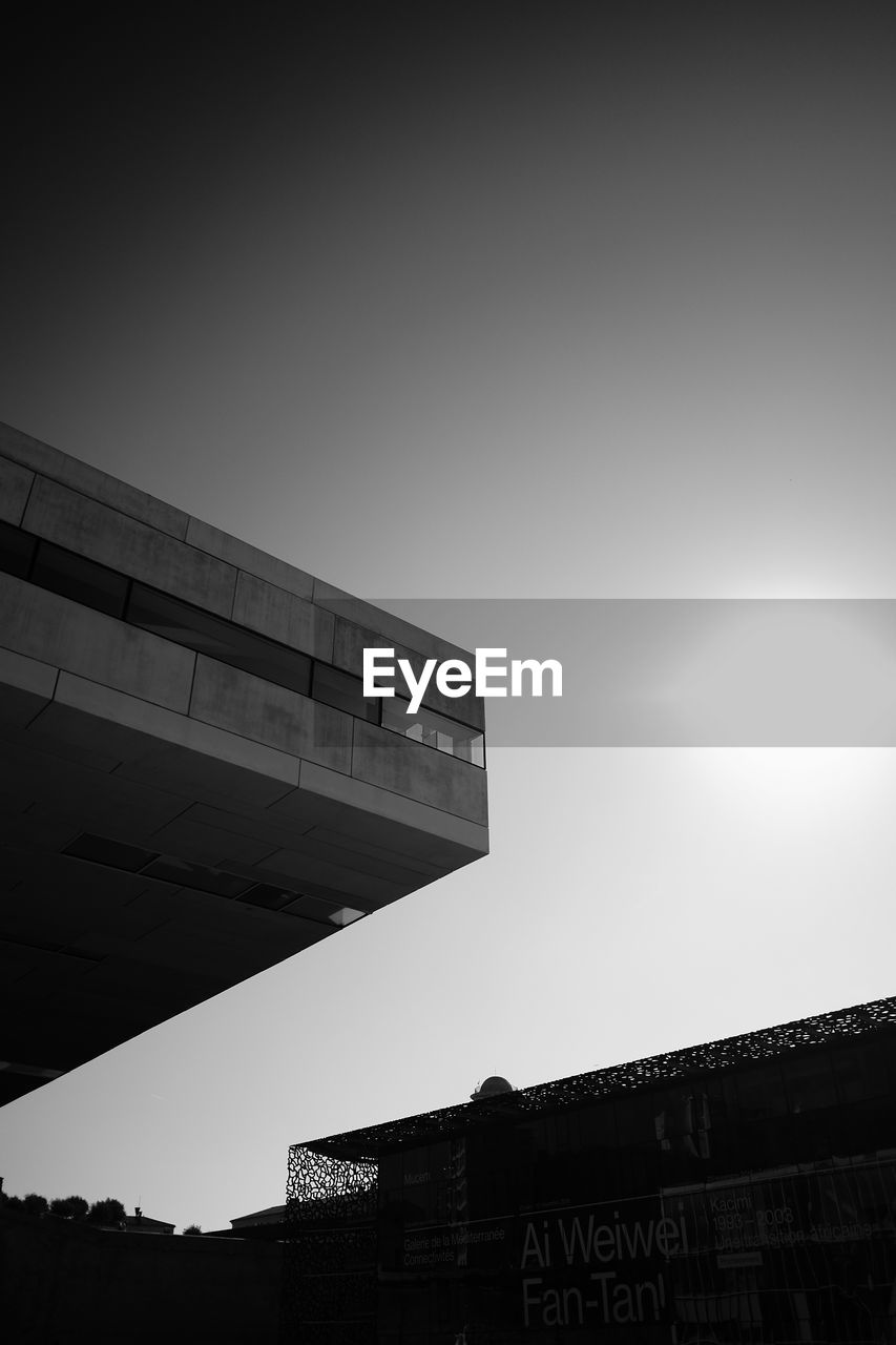 LOW ANGLE VIEW OF BUILDINGS AGAINST CLEAR SKY