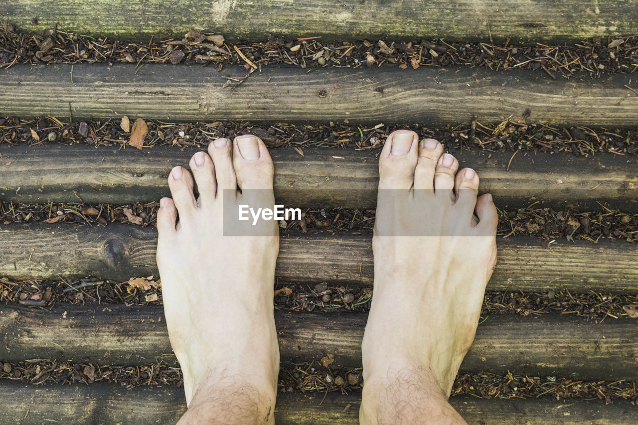 Low section of person on weathered wood