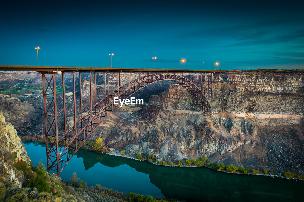 Arch bridge over river against sky