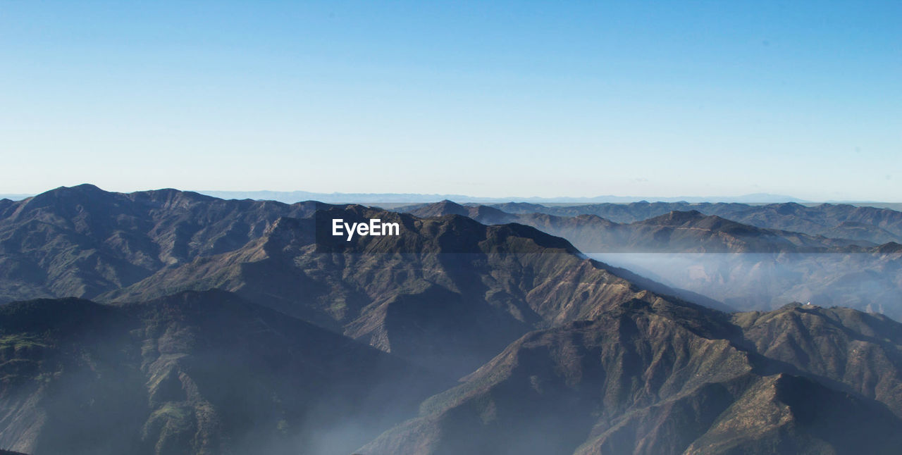 Scenic view of mountain range against clear sky
