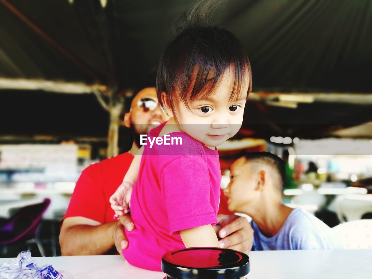 Father with children on table at restaurant