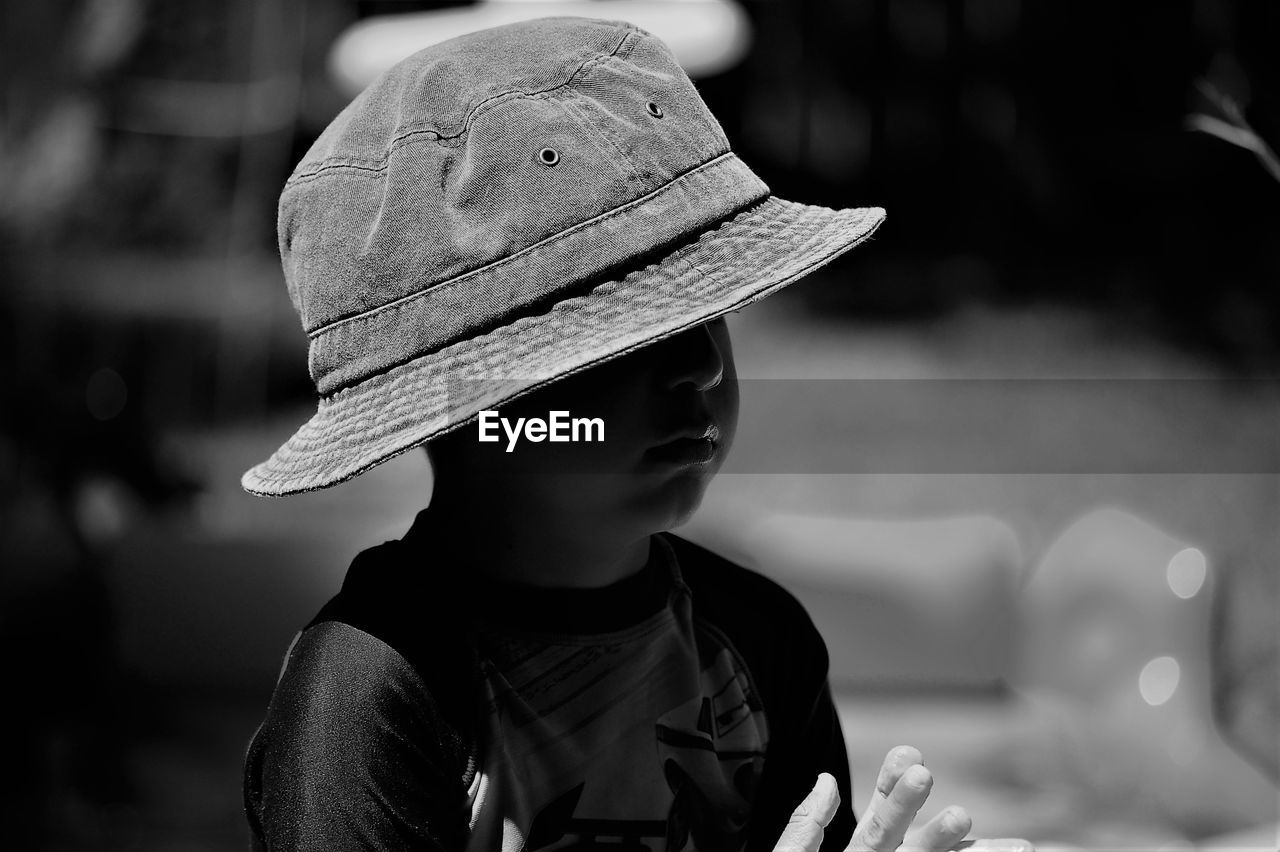 Close-up of boy wearing sun hat during sunny day