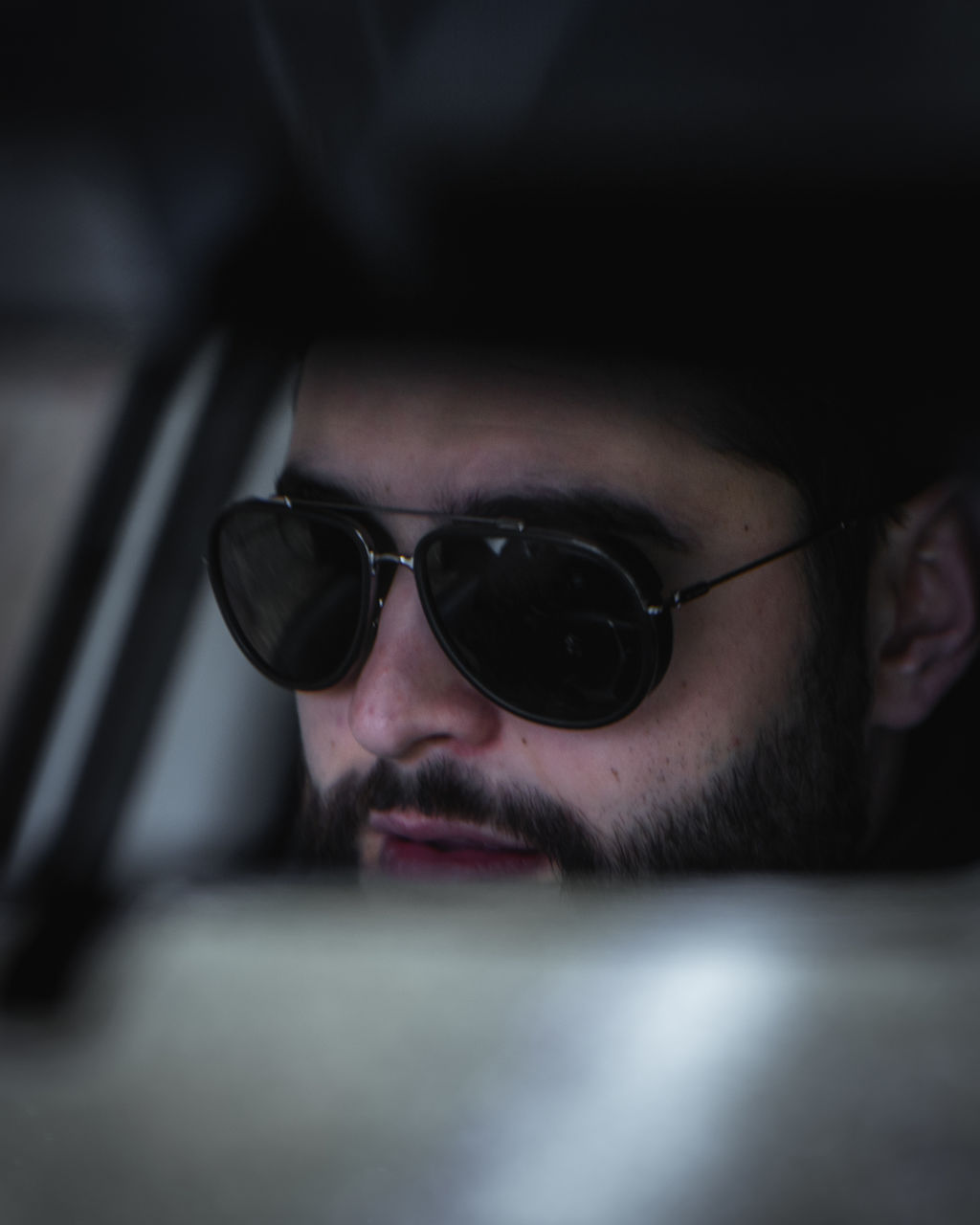 Close-up of man wearing sunglasses sitting in car