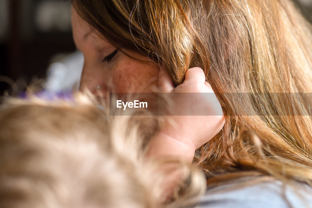 Close-up of woman with daughter at home