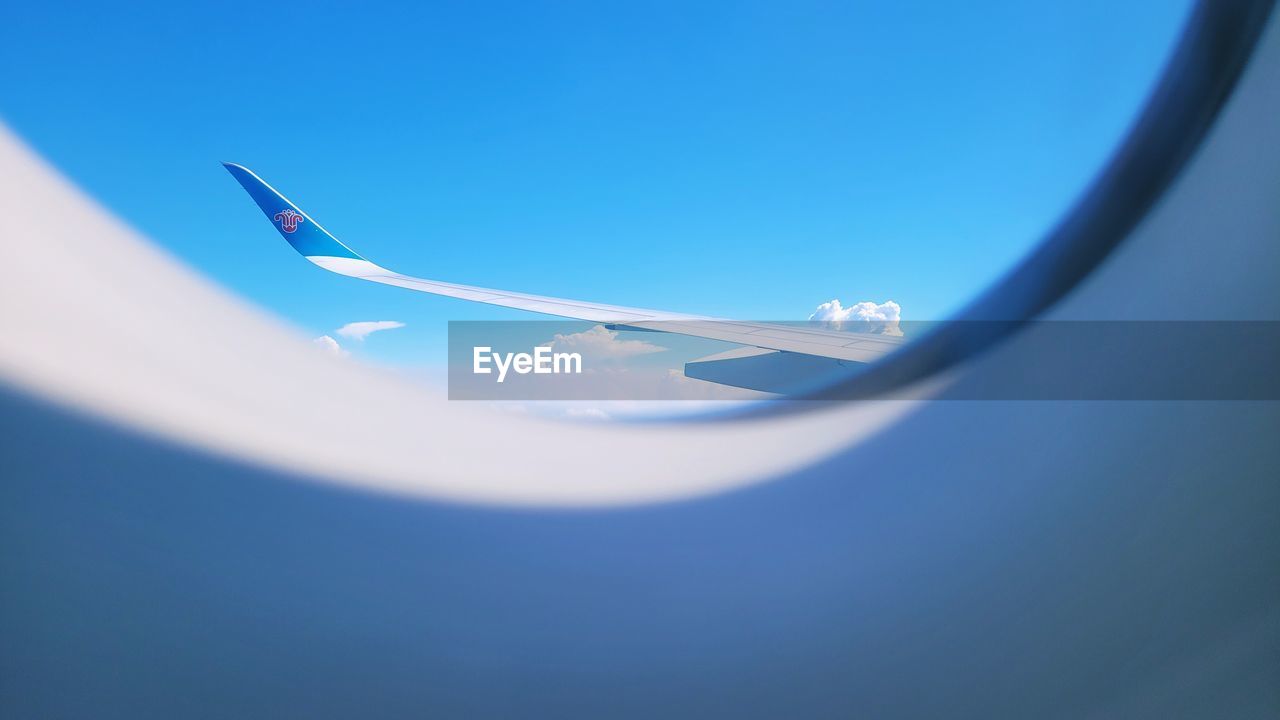 blue, airplane, air vehicle, flying, travel, transportation, no people, mode of transportation, sky, vehicle, nature, copy space, day, indoors, journey, aircraft wing