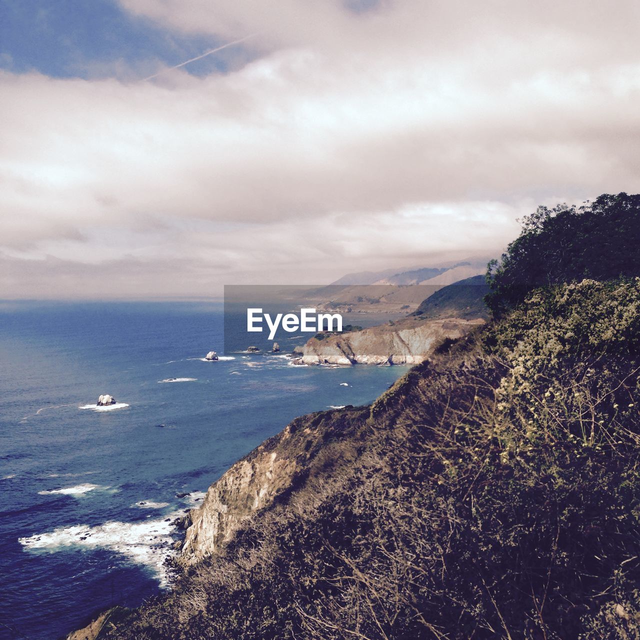 Scenic view of sea against cloudy sky