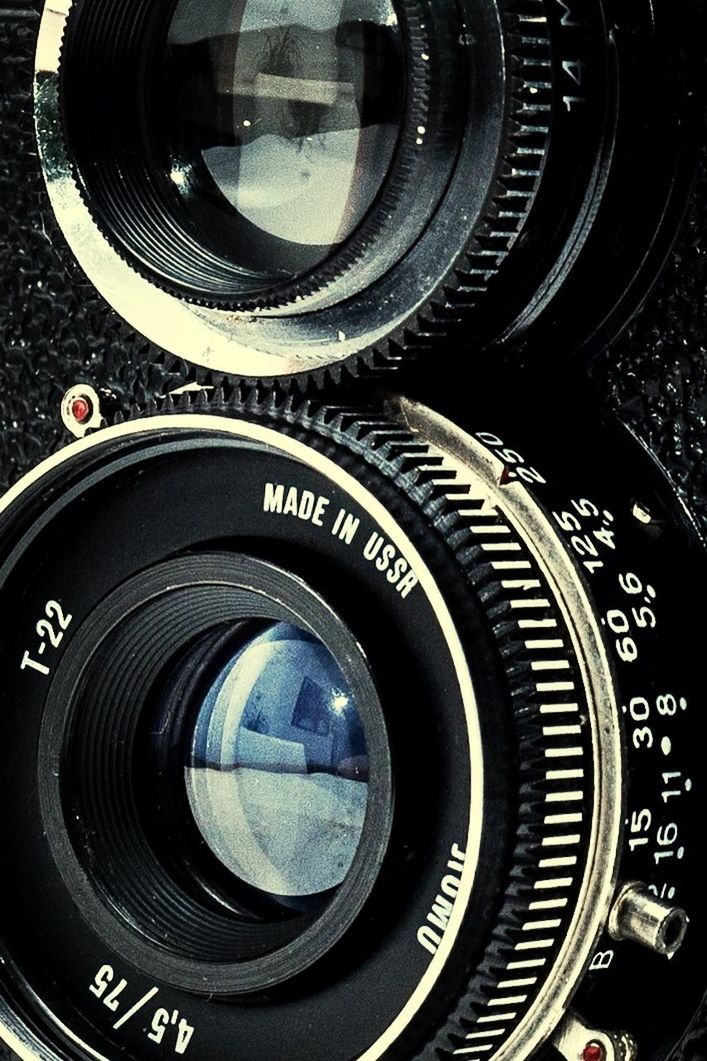 CLOSE-UP OF CAMERA ON WHITE TABLE