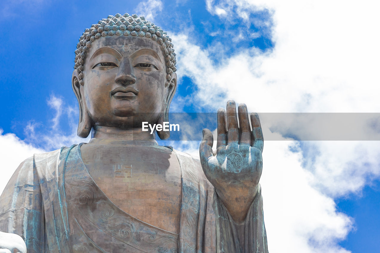 LOW ANGLE VIEW OF STATUE OF BUDDHA AGAINST SKY