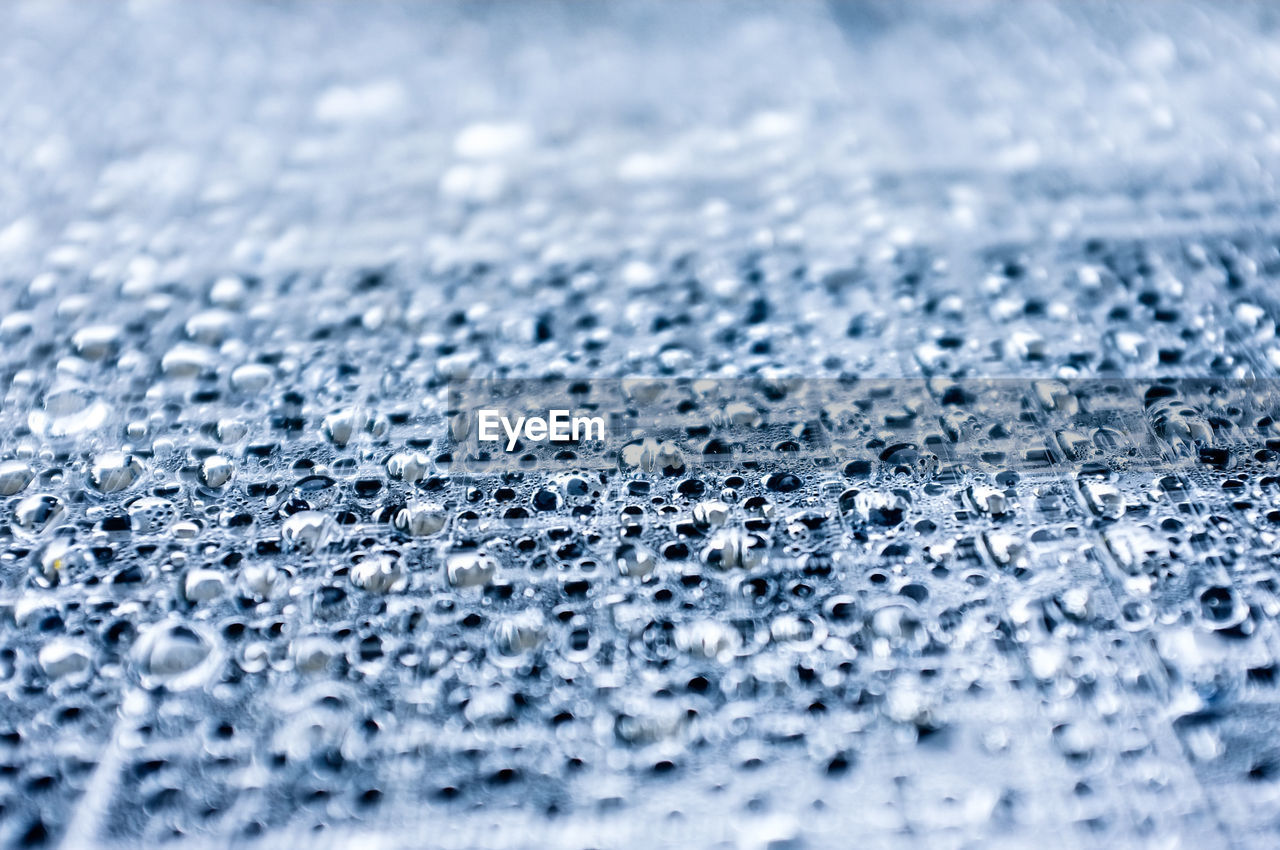 Full frame shot of rain drops on plastic membrane