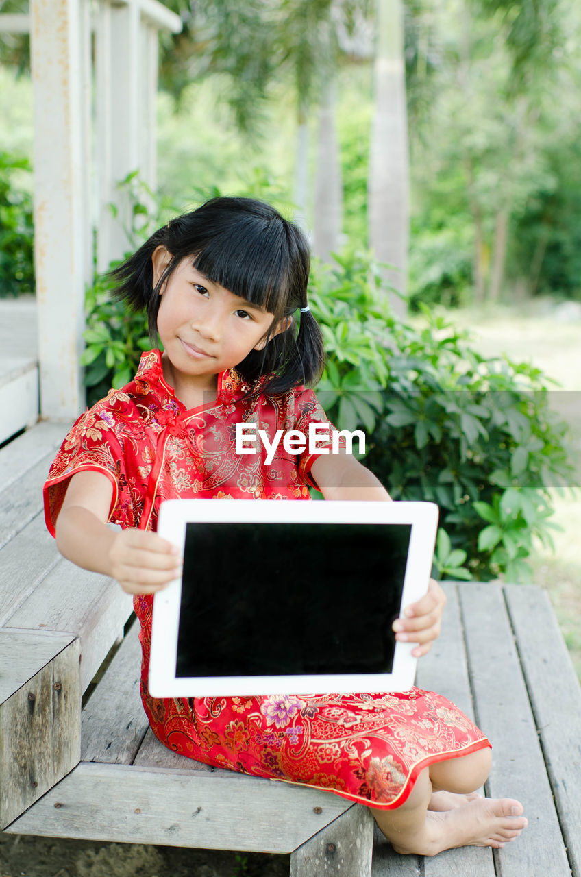 Portrait of girl holding slate