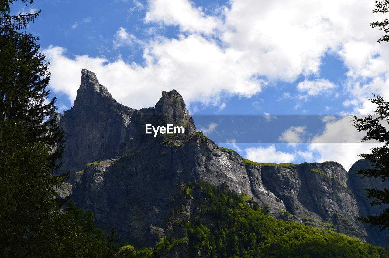 Scenic view of mountains against cloudy sky