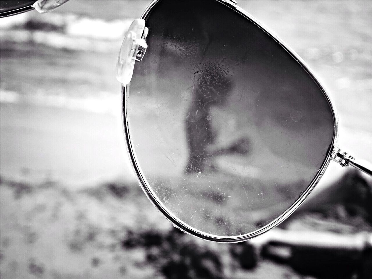 Close-up of sunglasses on beach