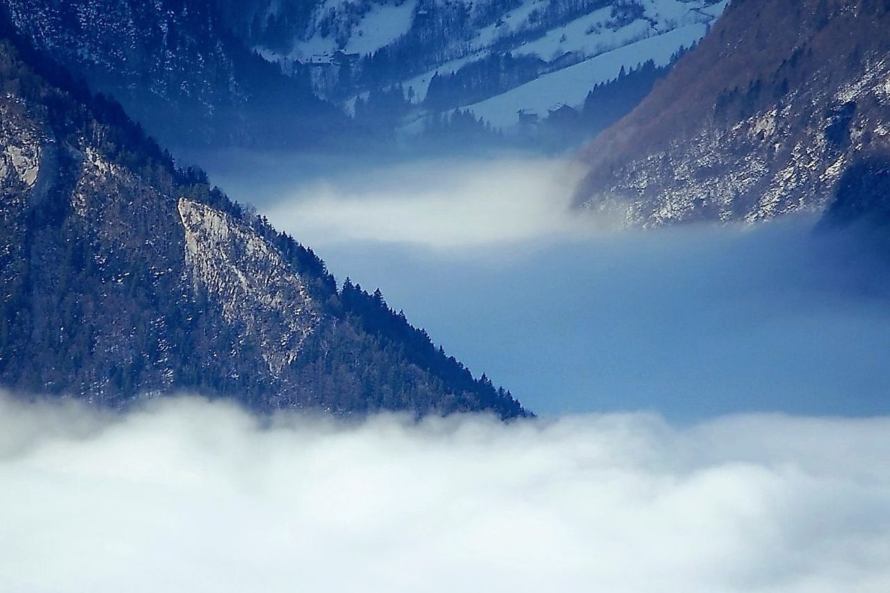 Scenic view of mountains against sky during winter