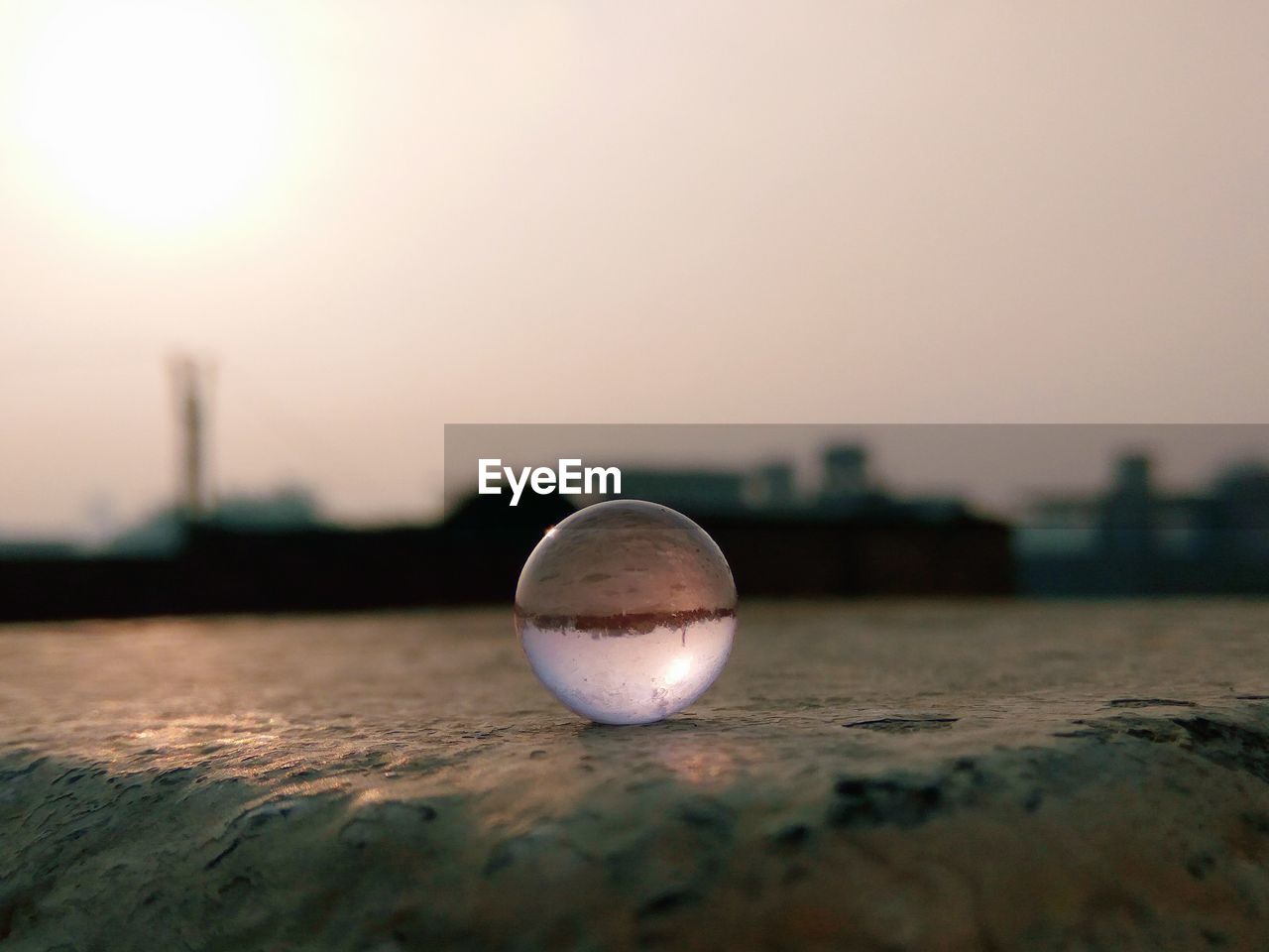 CLOSE-UP OF CRYSTAL BALL AGAINST CLEAR SKY