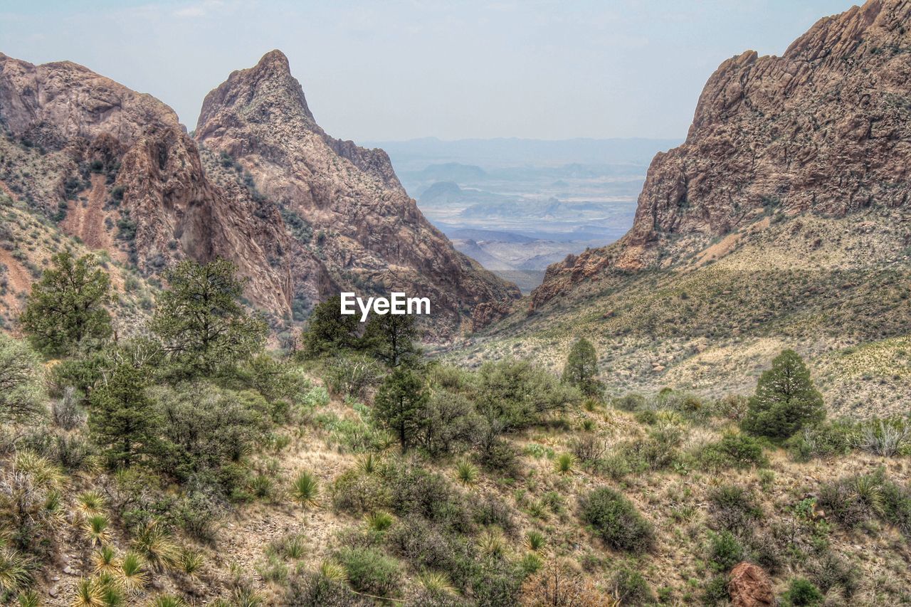 Scenic view of rocky mountains against cloudy sky