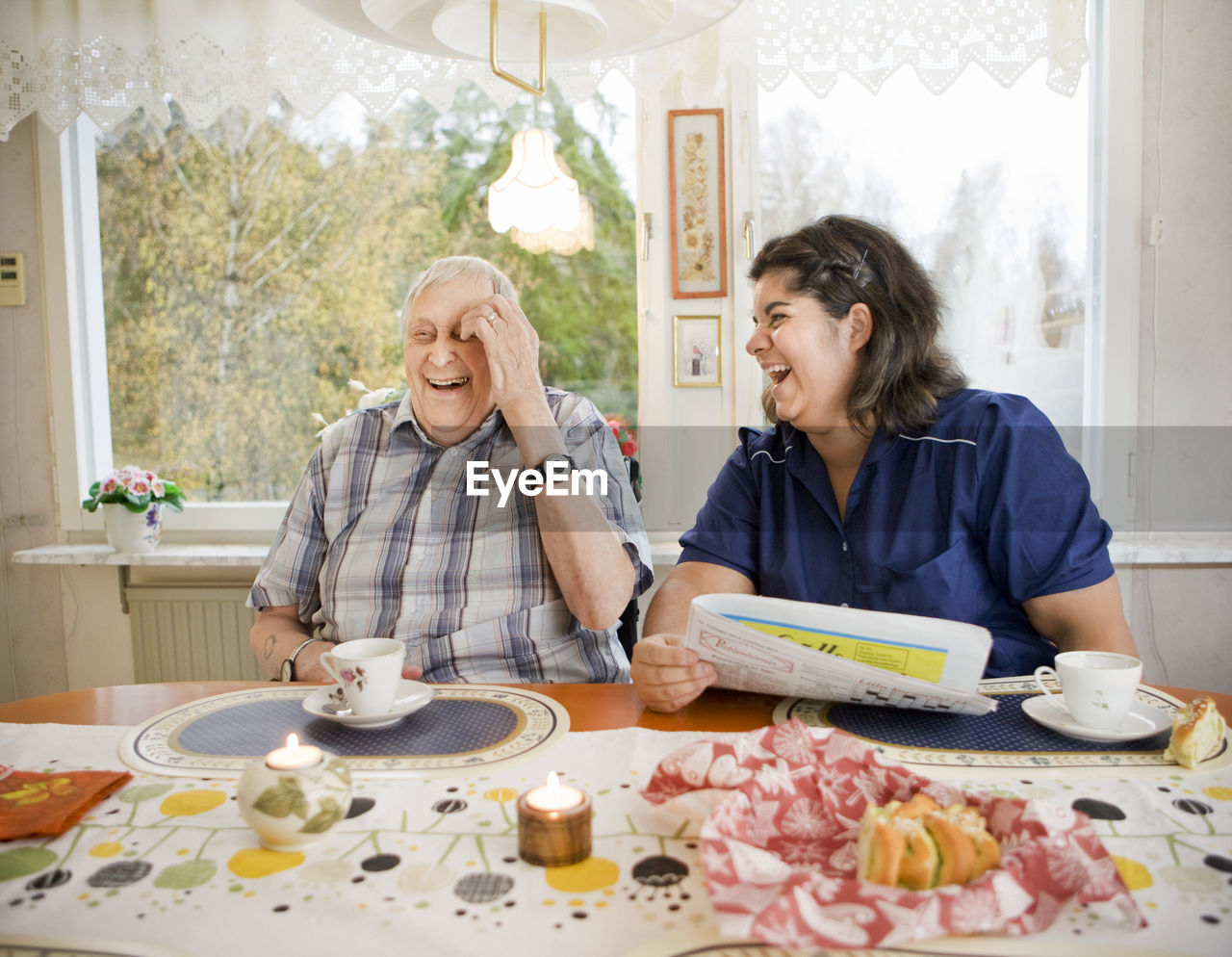 Nurse with senior man at table, sweden