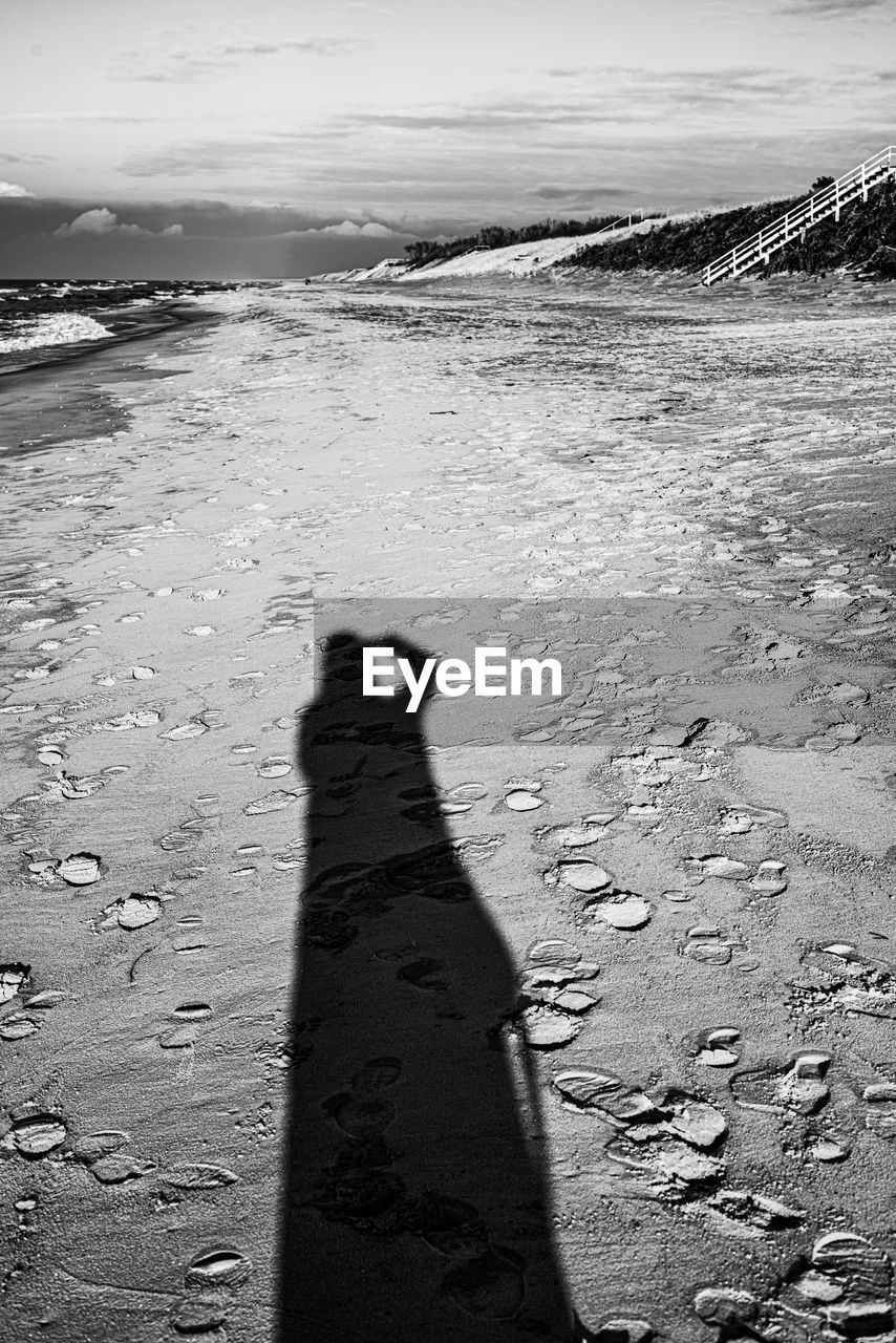 SHADOW OF PEOPLE ON SAND