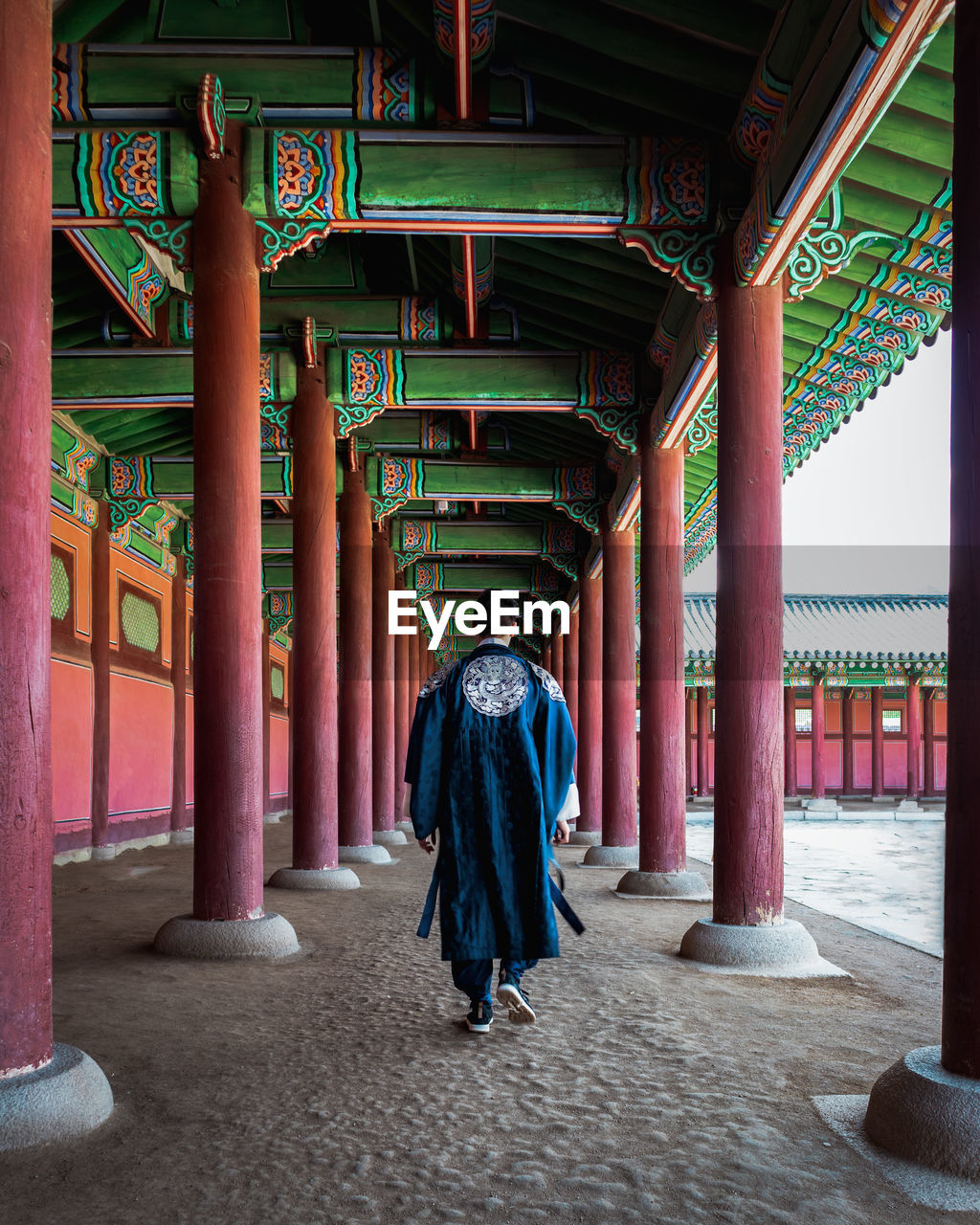 Korean man walking through the korean palace