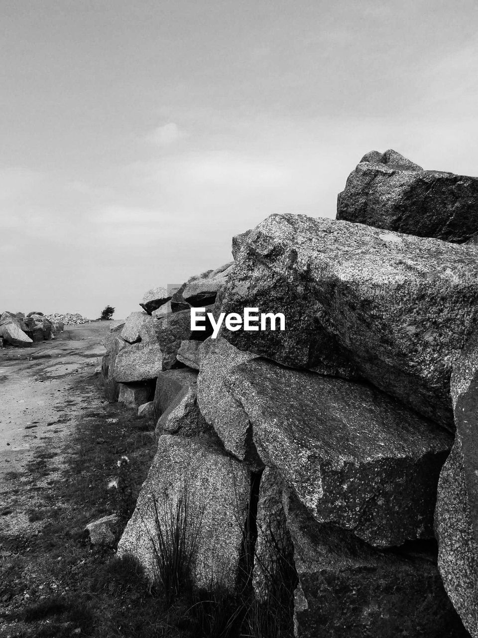 Stack of rocks on landscape against sky