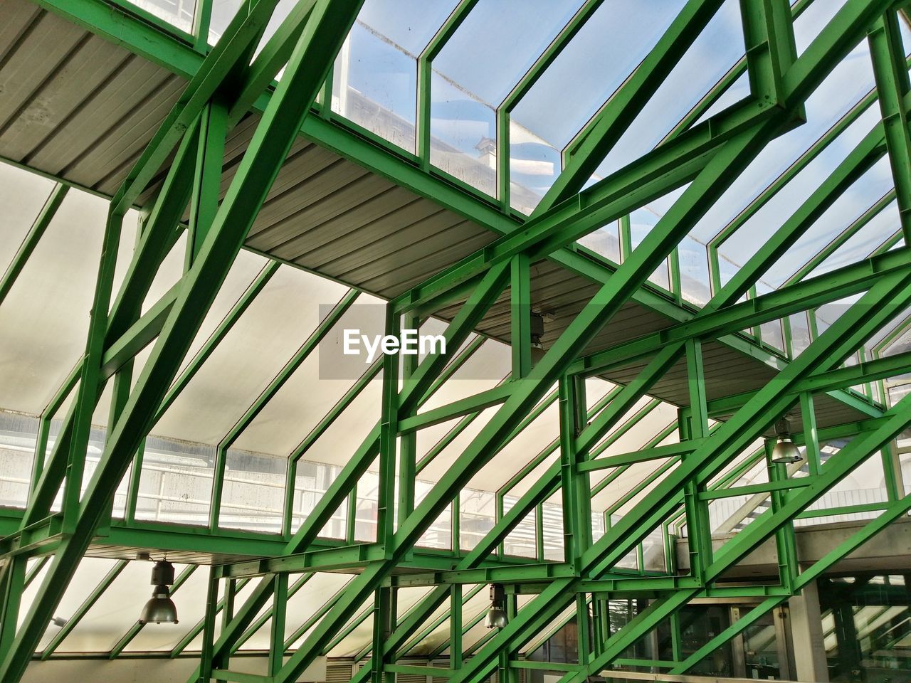 Low angle view of green metallic structures in building