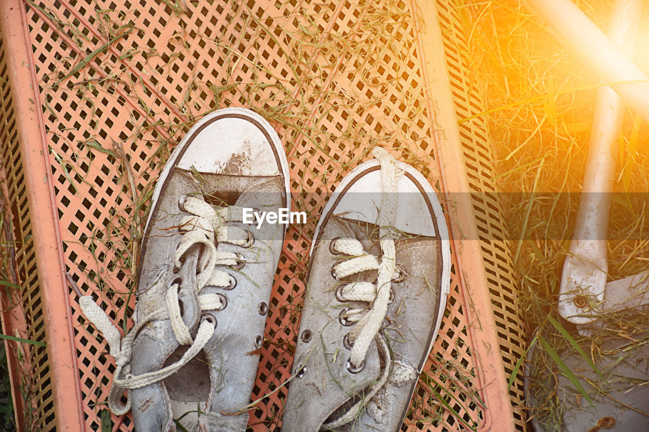 Close-up of abandoned shoes on metal