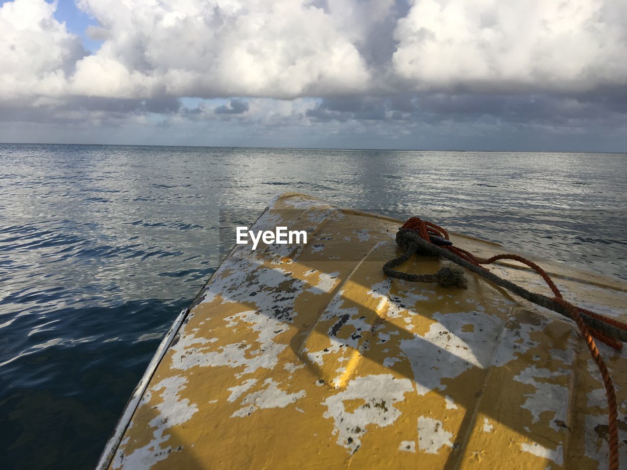 CLOSE-UP OF NAUTICAL VESSEL ON SEA AGAINST SKY