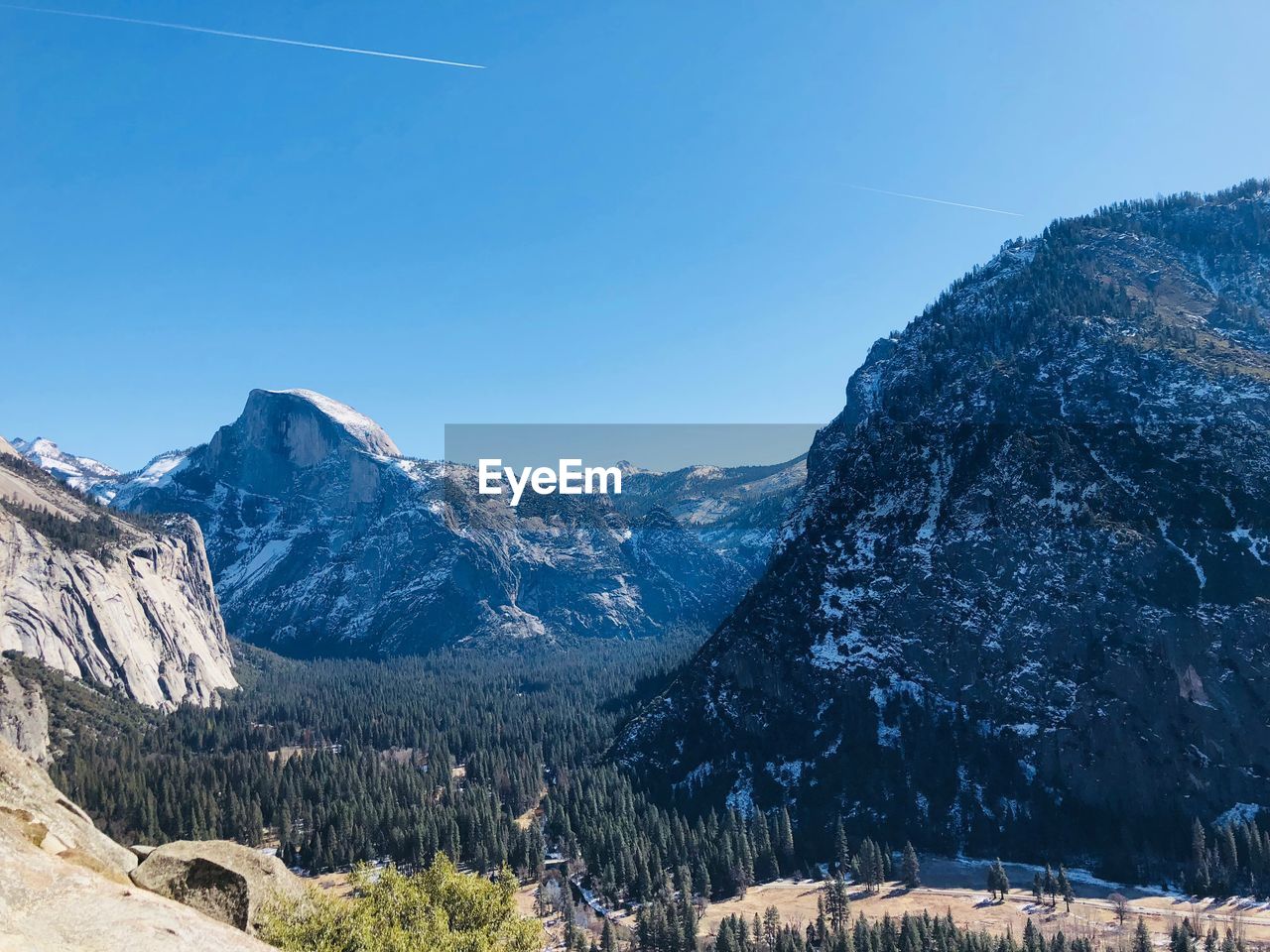 Scenic view of snowcapped mountains against clear blue sky